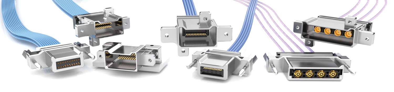 URSA IO Overview - Seven different rectangular and metallic electrical connectors with attached wires are shown in a row, each with visible gold or black contacts.